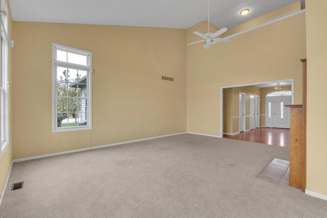 9080 Emerson Dr, Saline, MI 48176 - carpeted spare room featuring visible vents, baseboards, ceiling fan, and high vaulted ceiling