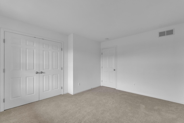 9080 Emerson Dr, Saline, MI 48176 - unfurnished bedroom with visible vents, baseboards, carpet floors, and a closet
