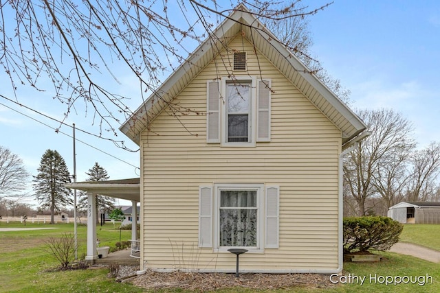 view of side of property with a yard