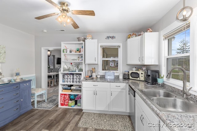 kitchen with white cabinets, dishwasher, a sink, and white microwave