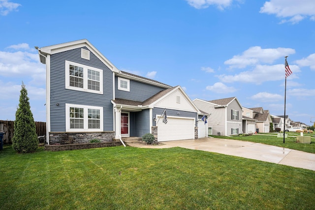 traditional-style home featuring an attached garage, fence, driveway, and a front lawn