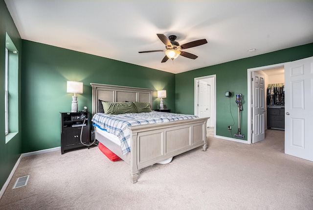 bedroom with baseboards, visible vents, a ceiling fan, and light colored carpet