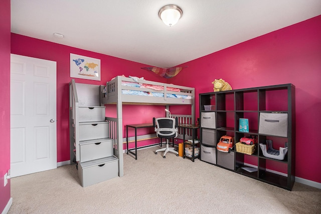carpeted bedroom featuring baseboards