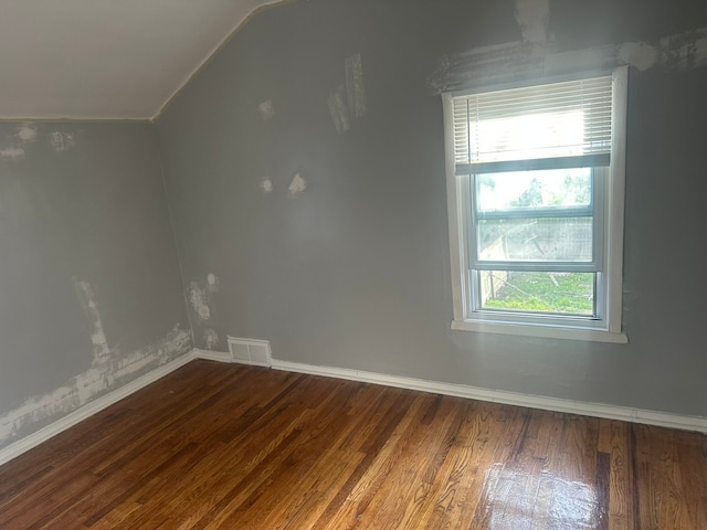 bonus room with visible vents, baseboards, wood finished floors, and a healthy amount of sunlight