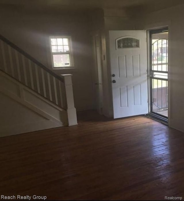 foyer featuring stairway and wood finished floors
