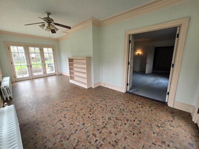 unfurnished living room with crown molding, baseboards, a ceiling fan, and french doors