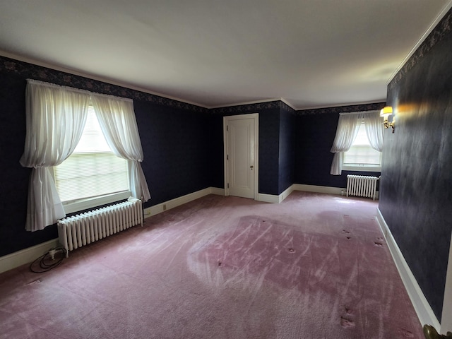 unfurnished room with radiator, baseboards, carpet flooring, and wallpapered walls