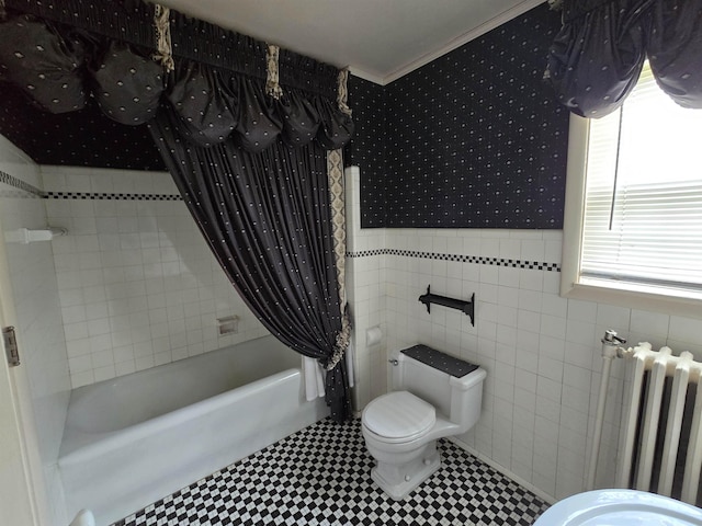 full bathroom featuring wainscoting, shower / bath combo, toilet, radiator, and wallpapered walls