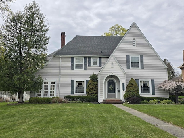 view of front of home featuring a front yard and a chimney