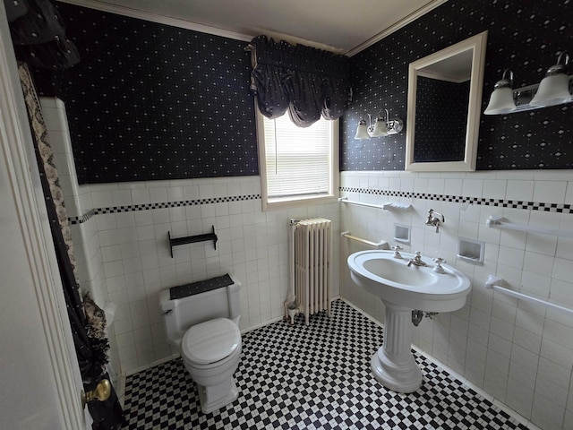 bathroom with wallpapered walls, ornamental molding, and radiator heating unit