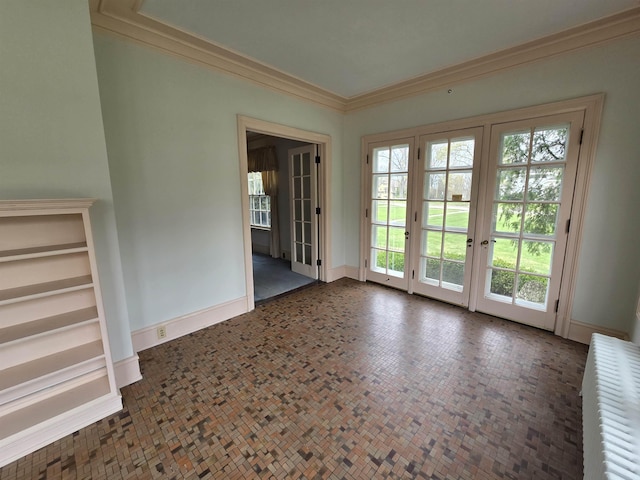doorway to outside featuring radiator heating unit, baseboards, and ornamental molding