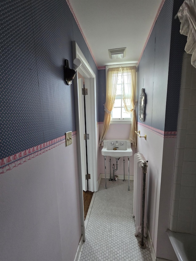 hallway featuring visible vents and radiator