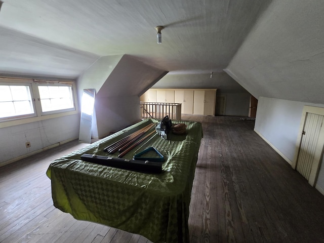 bedroom with lofted ceiling and hardwood / wood-style flooring