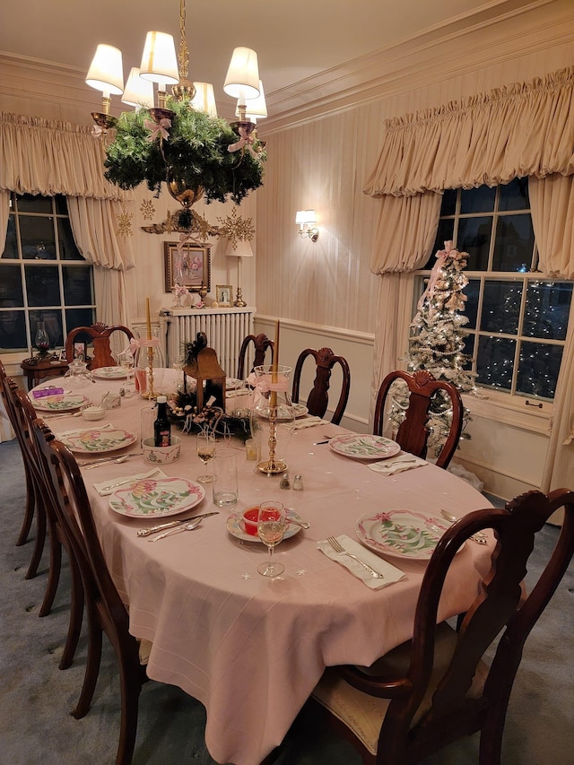 dining area featuring ornamental molding and carpet