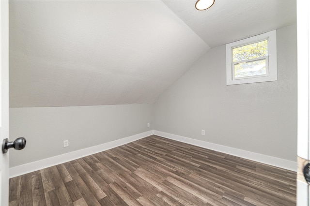 507 S Lincoln St, Bay City, MI 48708 - additional living space featuring baseboards, vaulted ceiling, and dark wood-style floors