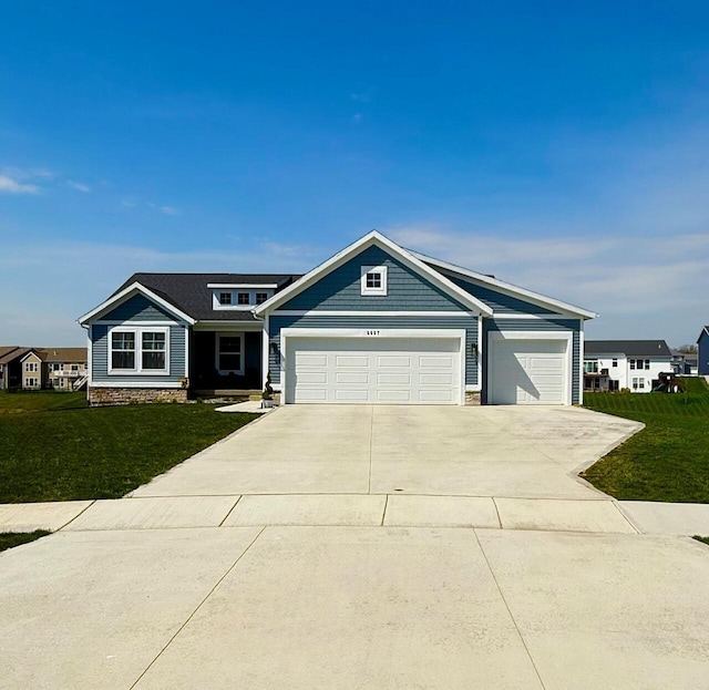 6657 Delia Dr, Hudsonville, MI 49426 - craftsman house with a garage, driveway, stone siding, and a front yard