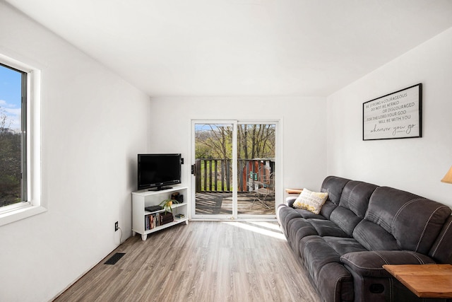 living room featuring visible vents and wood finished floors