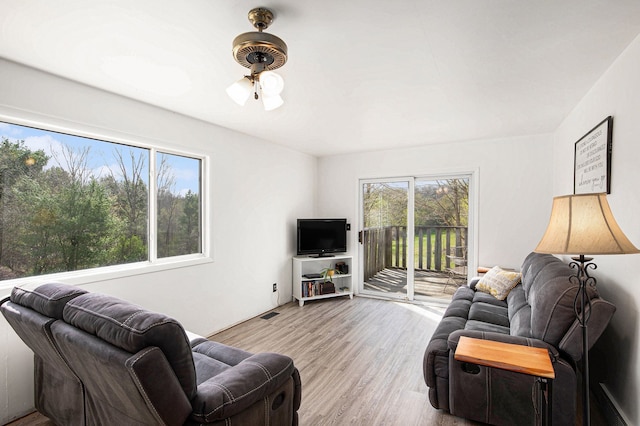 living area with a ceiling fan and light wood-style floors