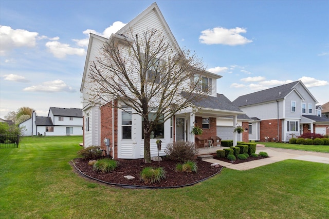 view of front of property featuring brick siding, a front lawn, and concrete driveway