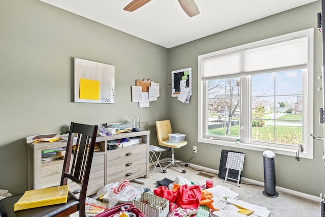 office space featuring baseboards, carpet flooring, and a ceiling fan