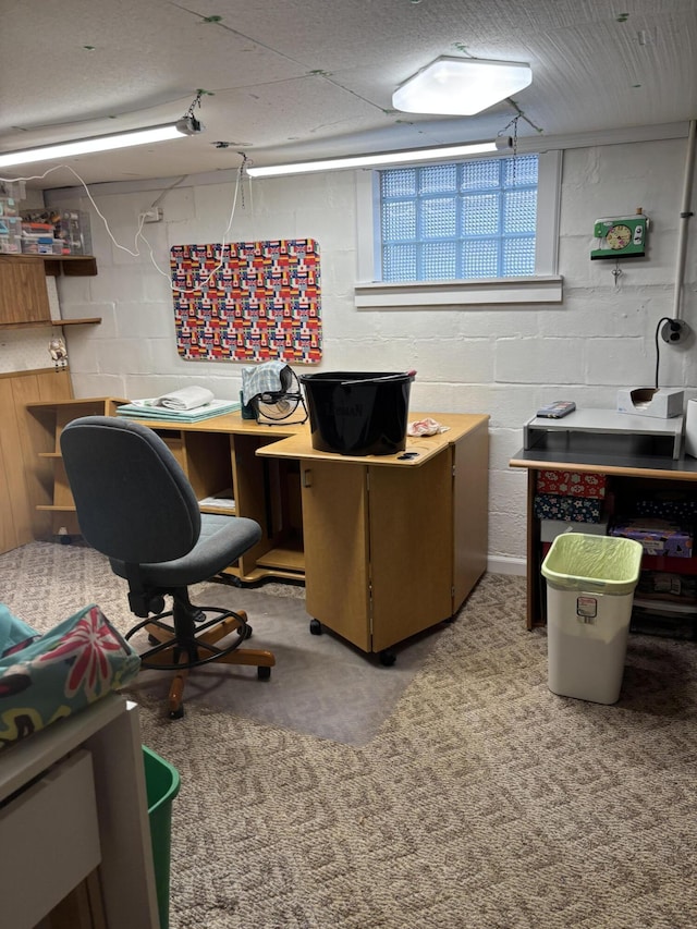 office area with carpet floors and concrete block wall