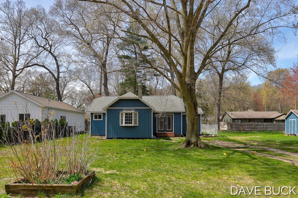 15242 152nd Ave, Spring Lake, MI 49456 - exterior space with a chimney, fence, an outbuilding, and a front yard