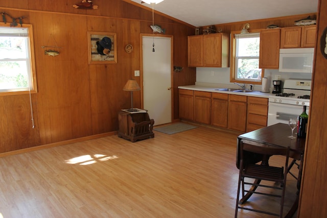17980 1ST Callejon, Barryton, MI 49305 - kitchen featuring vaulted ceiling, brown cabinets, a sink, light countertops, and white appliances