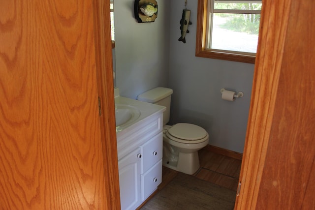 17980 1ST Callejon, Barryton, MI 49305 - half bathroom featuring vanity, baseboards, wood finished floors, and toilet