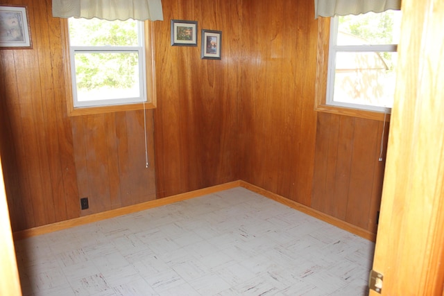 17980 1ST Callejon, Barryton, MI 49305 - spare room with tile patterned floors, wooden walls, and a healthy amount of sunlight