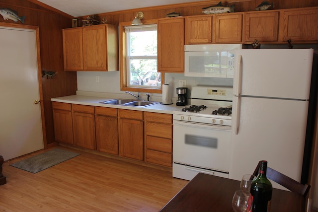 17980 1ST Callejon, Barryton, MI 49305 - kitchen featuring brown cabinets, a sink, light wood finished floors, white appliances, and light countertops