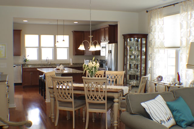 dining space with dark wood finished floors, recessed lighting, and a chandelier