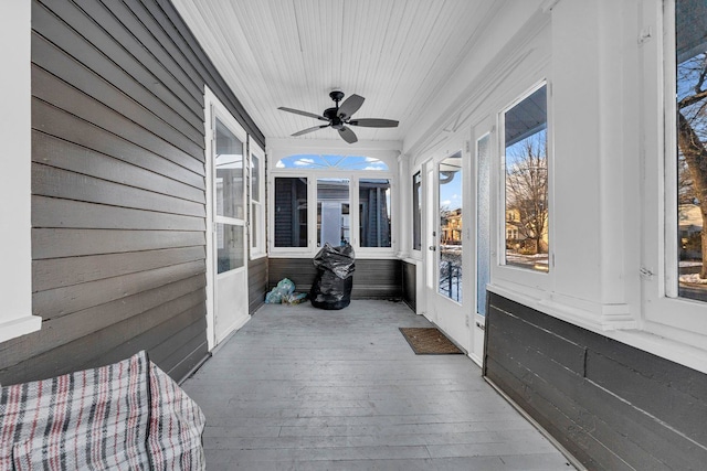 sunroom / solarium with a ceiling fan