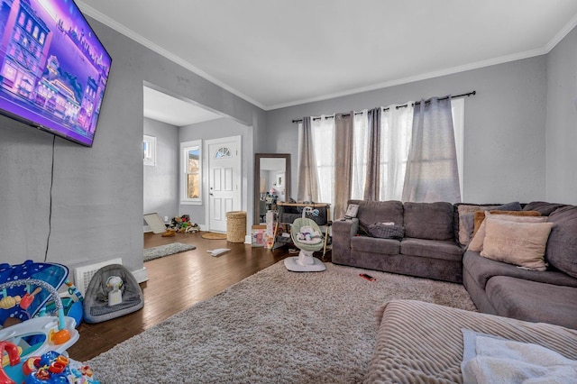living area with crown molding and wood finished floors