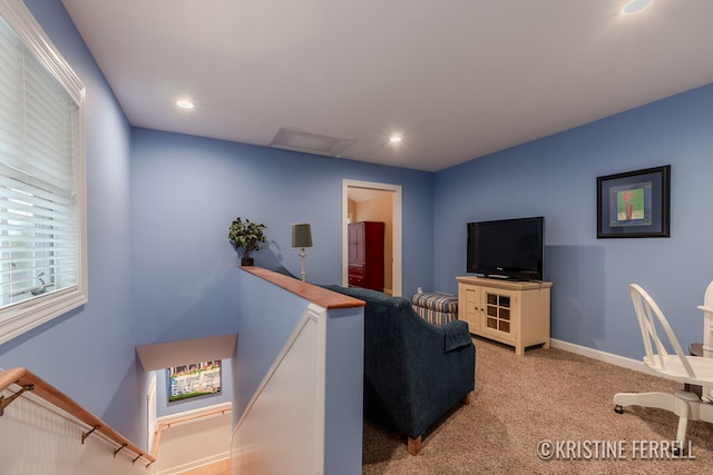 carpeted living area with recessed lighting, baseboards, and attic access