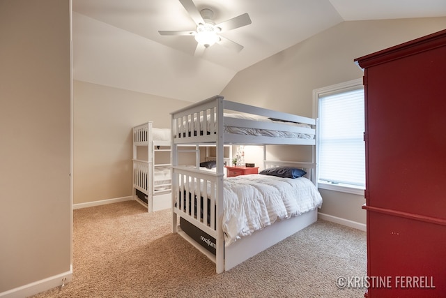 carpeted bedroom featuring baseboards, ceiling fan, and vaulted ceiling