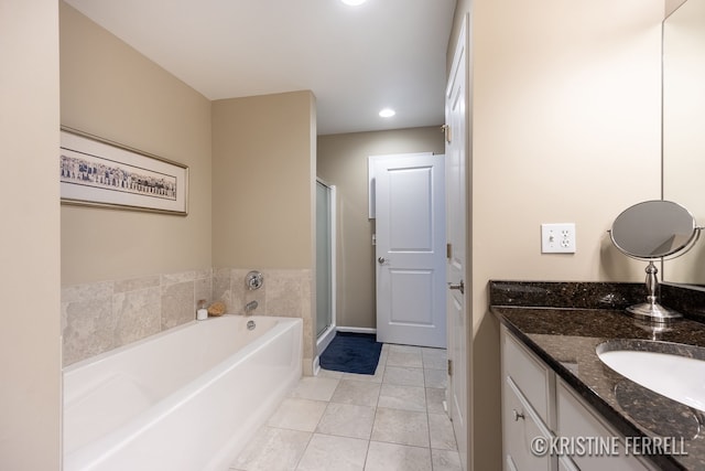 bathroom with a bath, tile patterned flooring, a stall shower, vanity, and recessed lighting