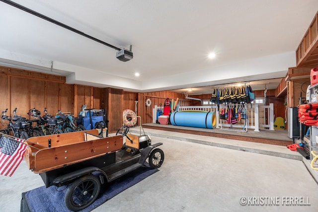garage featuring wooden walls and a garage door opener