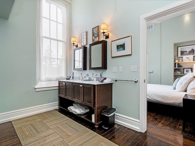 800-204 Cottageview Dr, Traverse City, MI 49684 - ensuite bathroom featuring visible vents, baseboards, vanity, ensuite bath, and hardwood / wood-style floors