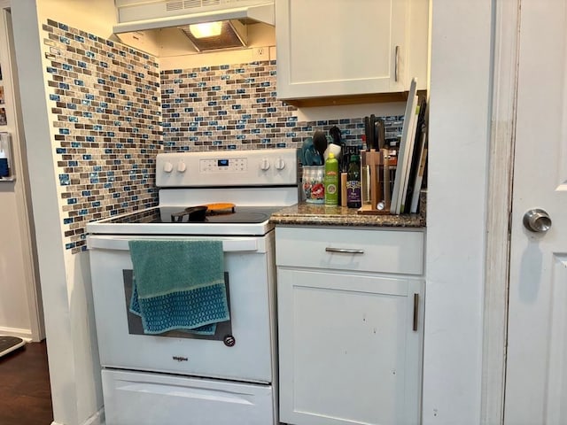 kitchen with white range with electric cooktop, under cabinet range hood, tasteful backsplash, and white cabinets
