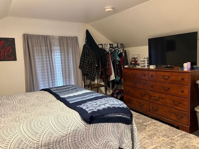 carpeted bedroom with vaulted ceiling