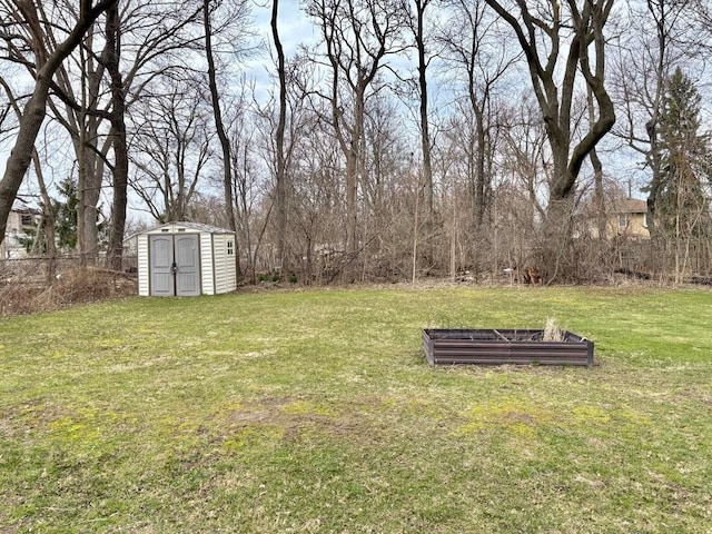 view of yard with a storage shed, fence, a garden, and an outdoor structure