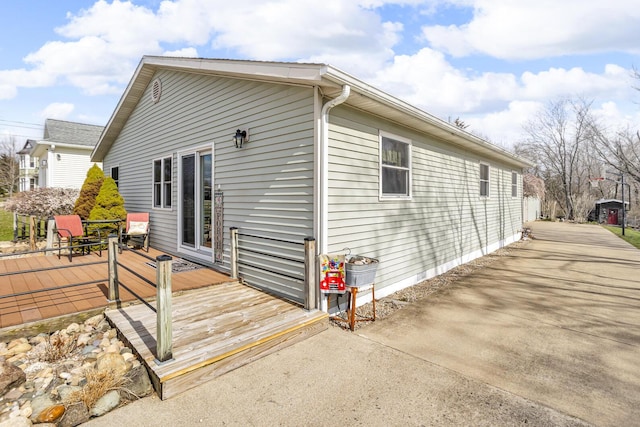 220 Nottingham Dr, Brooklyn, MI 49230 - view of side of home with a wooden deck