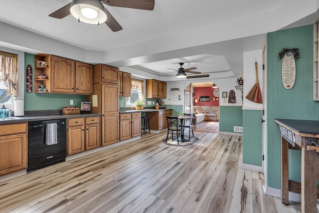 220 Nottingham Dr, Brooklyn, MI 49230 - kitchen featuring brown cabinetry, a ceiling fan, dishwasher, light wood finished floors, and a tray ceiling