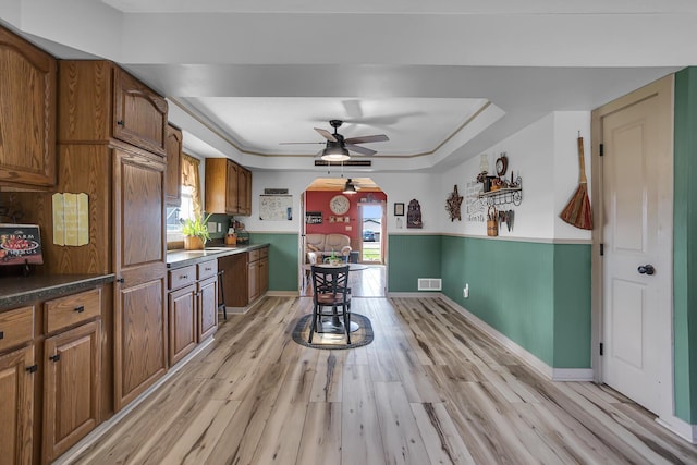 220 Nottingham Dr, Brooklyn, MI 49230 - kitchen featuring ceiling fan, brown cabinets, light wood-style flooring, and visible vents