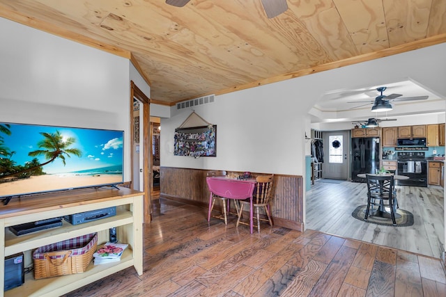 220 Nottingham Dr, Brooklyn, MI 49230 - interior space featuring a ceiling fan, wainscoting, wood ceiling, and light wood-style floors