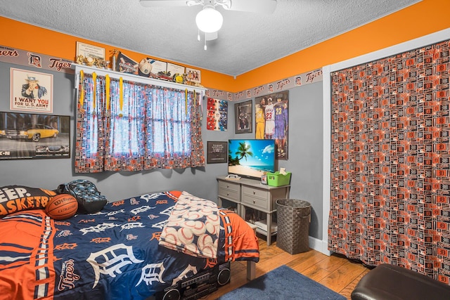 220 Nottingham Dr, Brooklyn, MI 49230 - bedroom featuring a textured ceiling, a ceiling fan, and wood finished floors