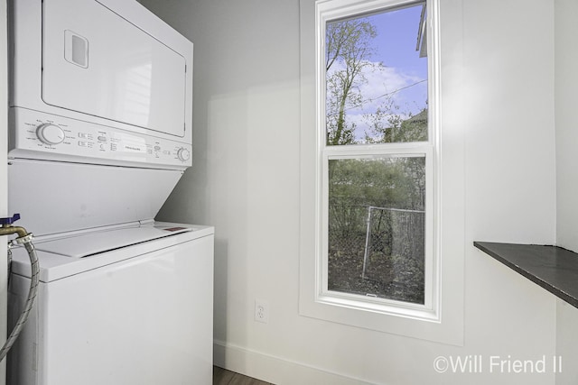 clothes washing area with stacked washer / drying machine and laundry area
