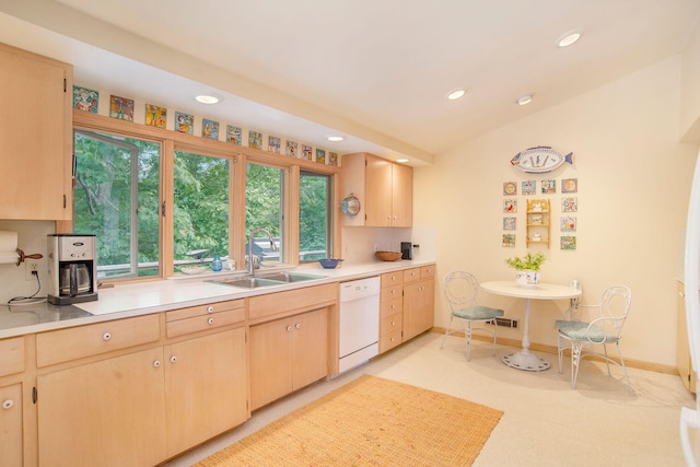 kitchen featuring light brown cabinetry, recessed lighting, light countertops, a sink, and dishwasher