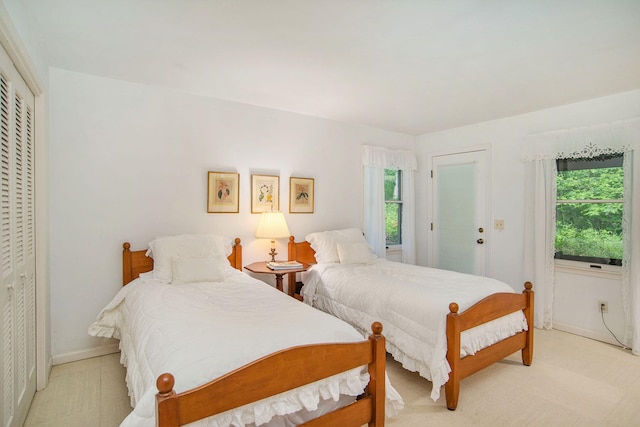 bedroom featuring baseboards and multiple windows