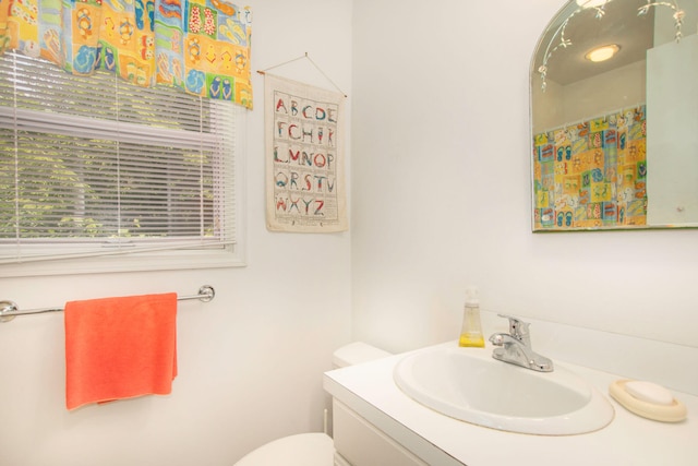 full bathroom featuring toilet and vanity